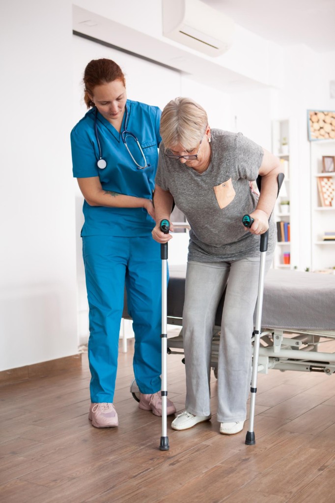 Carer and elderly woman smiling